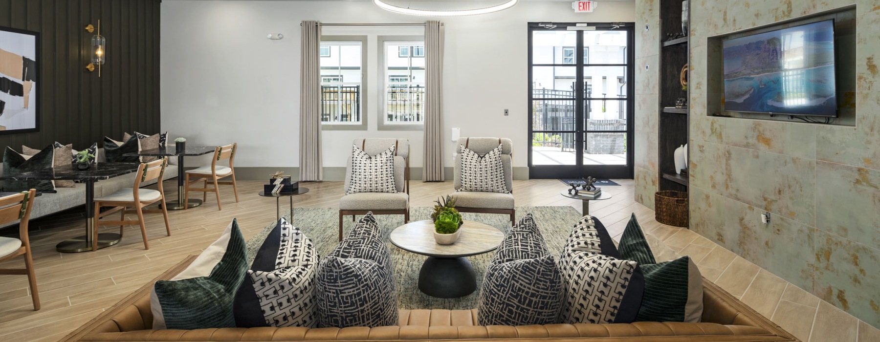 room with couch chairs and hanging tv